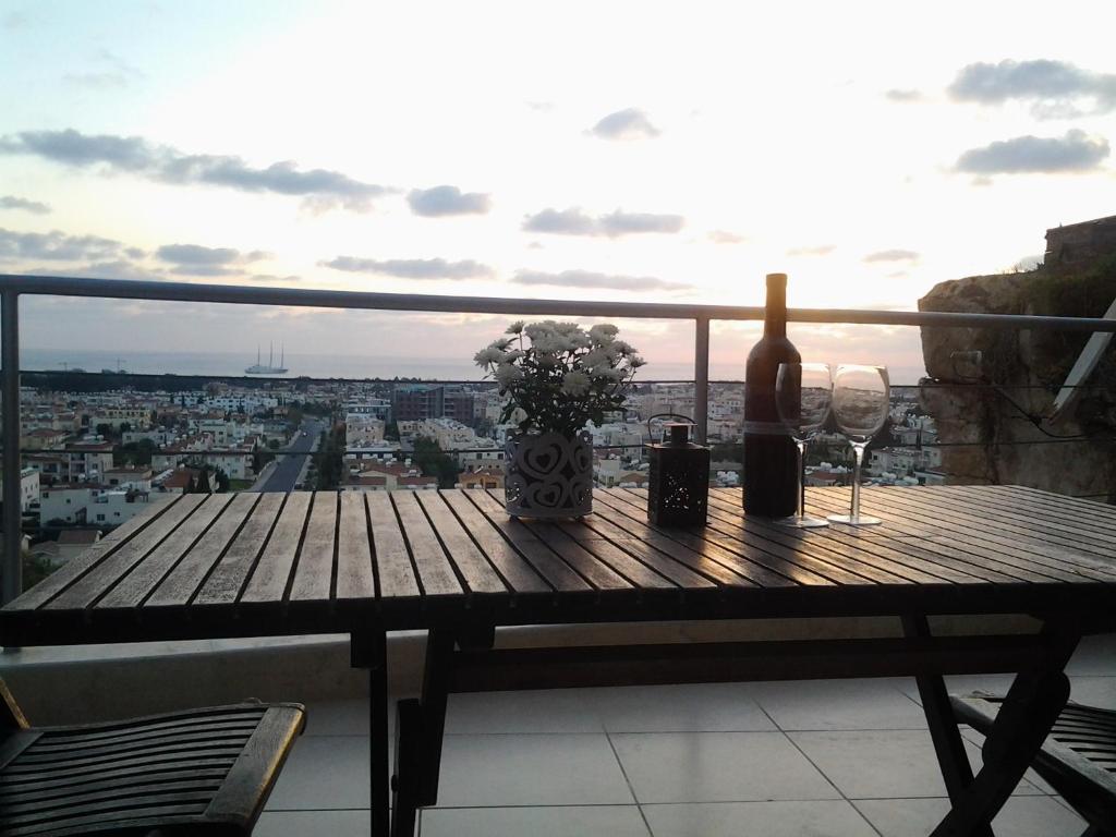 einen Holztisch mit Weingläsern und eine Flasche Wein in der Unterkunft The Best in Paphos City