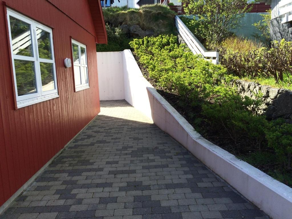 a brick walkway leading to a door of a house at Comfy in the center in Tórshavn