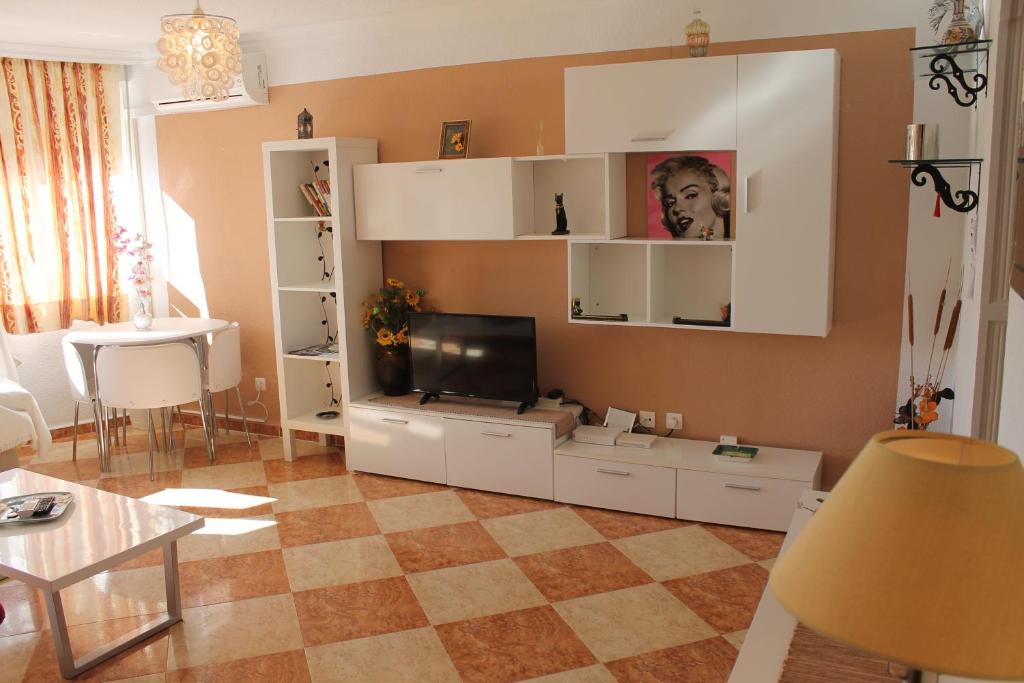 a living room with a large white entertainment center at Casa Vega in Benidorm