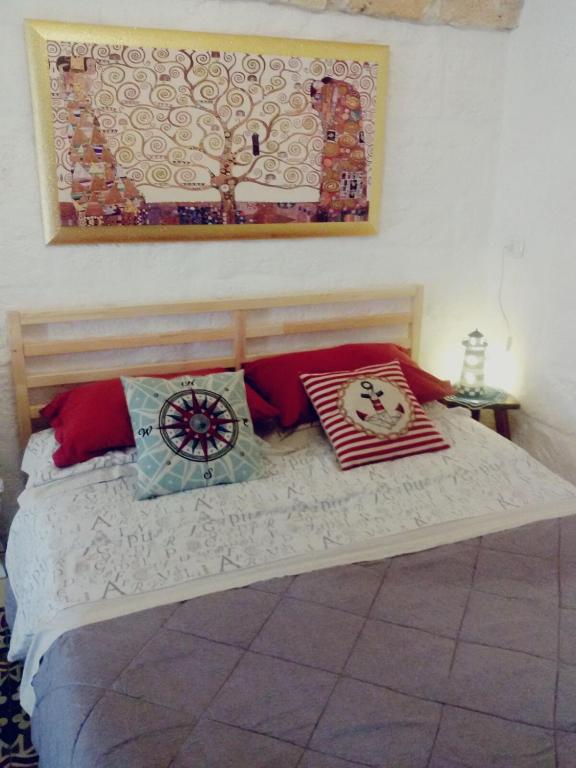 a bedroom with a bed with pillows on it at La Casa Di Lo in Monopoli