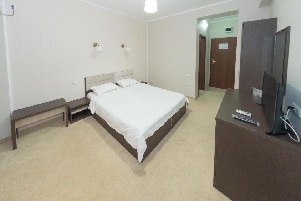 Postel nebo postele na pokoji v ubytování Hotel Promenada