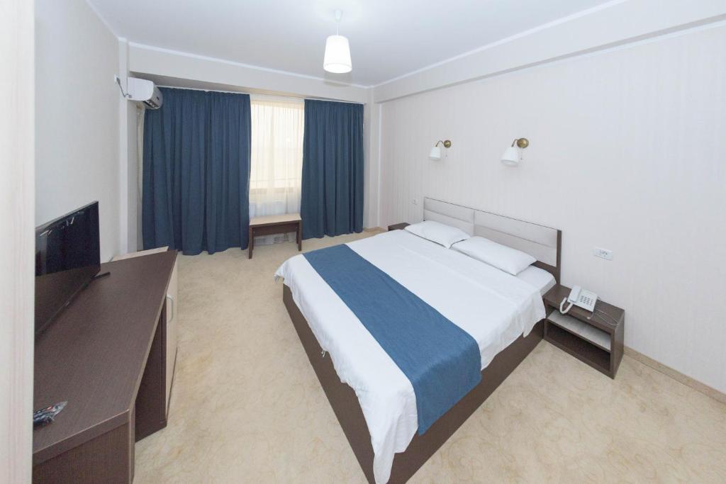 Postel nebo postele na pokoji v ubytování Hotel Promenada