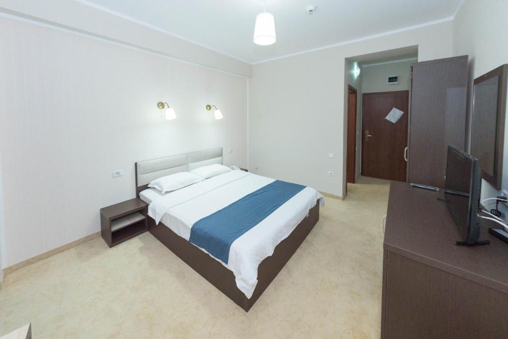 Postel nebo postele na pokoji v ubytování Hotel Promenada