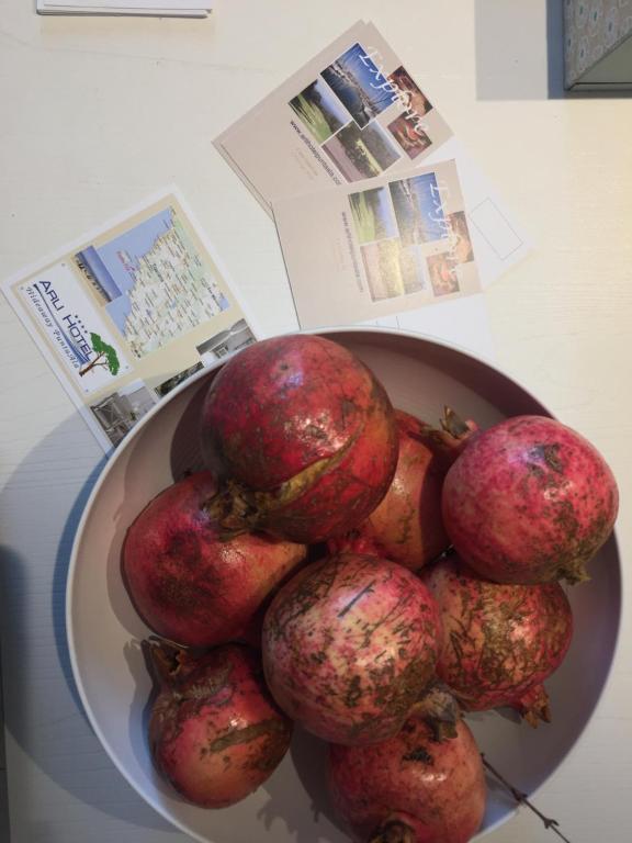 a bowl of pomegranates sitting on a table at Arli Hotel Hideaway Punta Ala - Adults Only in Punta Ala