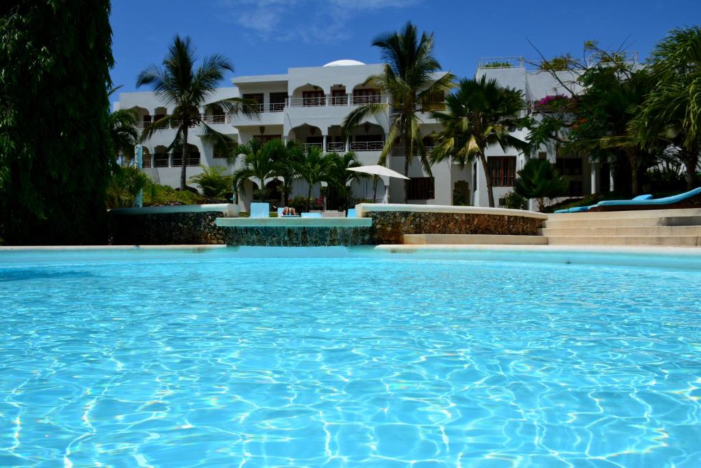 a large swimming pool in front of a building at Amani Residence Beverly Suites in Malindi