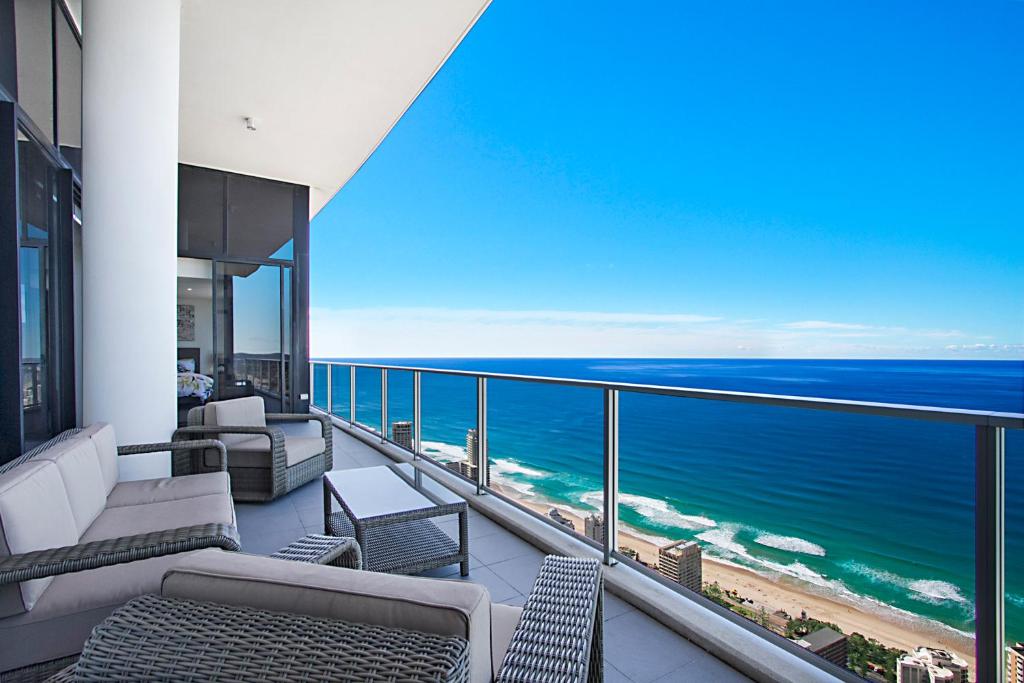 a balcony with chairs and a view of the ocean at Circle on Cavill 2, 3, 4 & 5 Bedroom SkyHomes & SUB PENTHOUSES by Gold Coast Holidays in Gold Coast