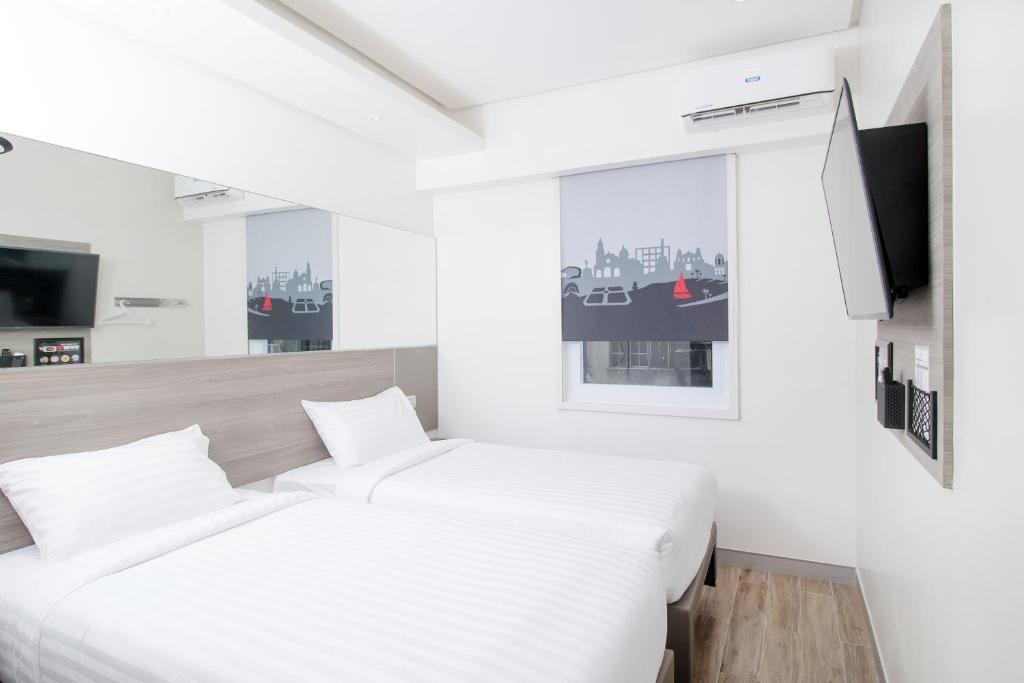 Postel nebo postele na pokoji v ubytování Red Planet Manila Bay