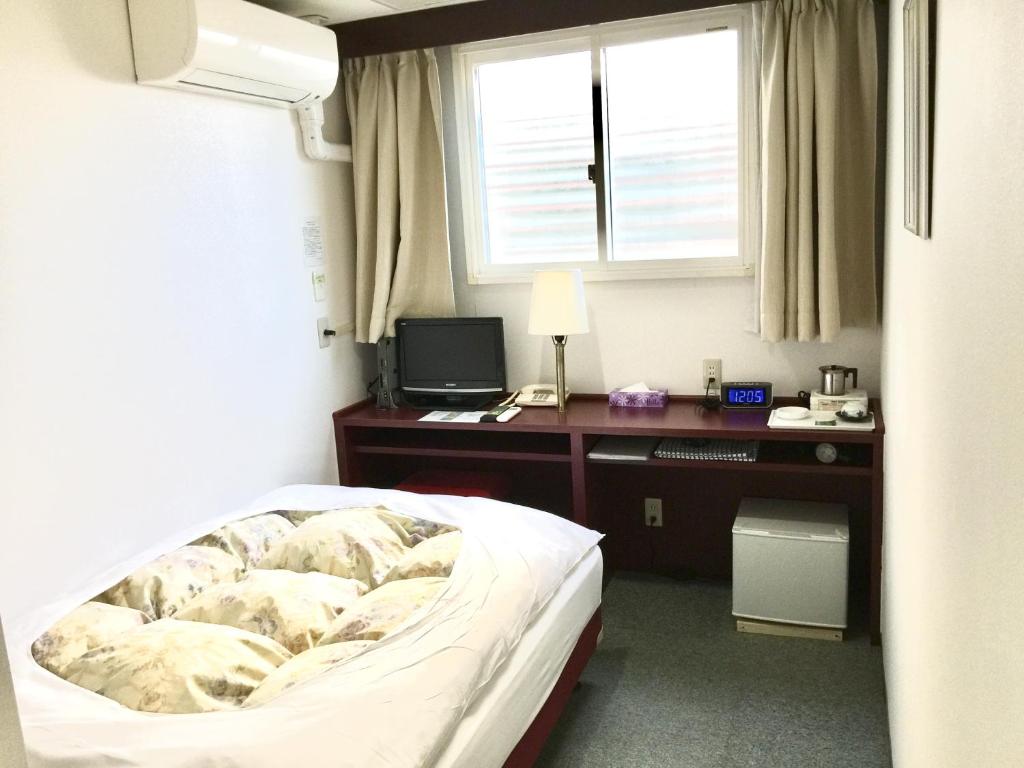 Postel nebo postele na pokoji v ubytování Green Hill Hotel Tennoji Ekimae