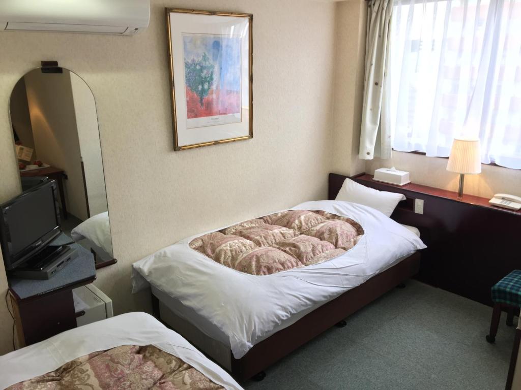 Postel nebo postele na pokoji v ubytování Green Hill Hotel Tennoji Ekimae