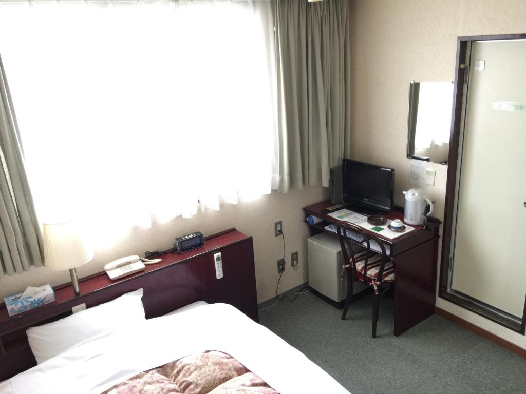 Postel nebo postele na pokoji v ubytování Green Hill Hotel Tennoji Ekimae