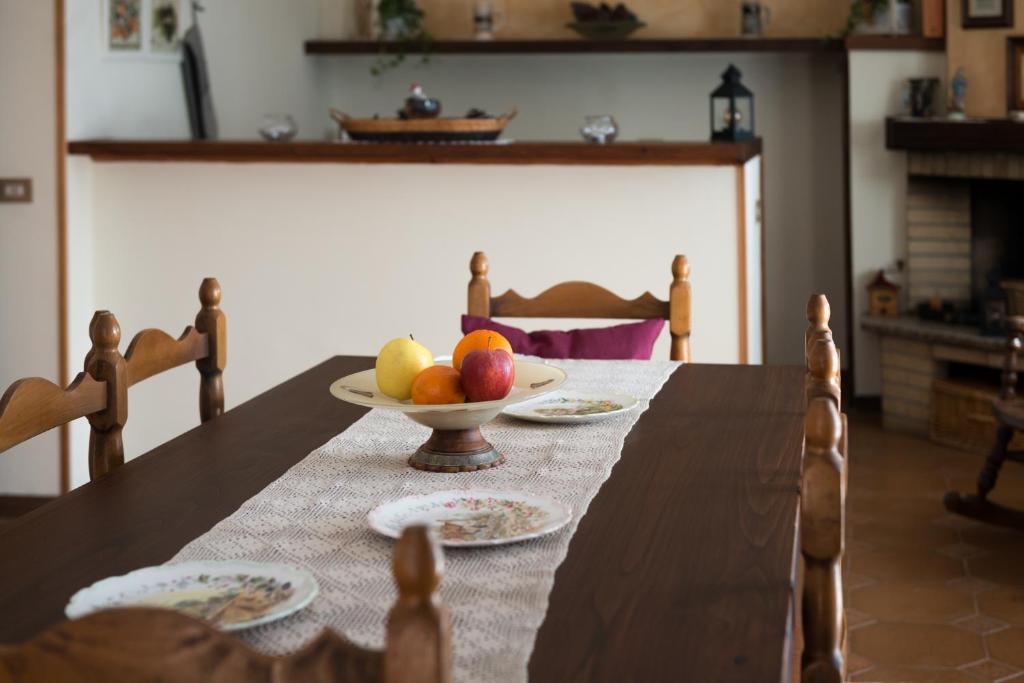 a wooden table with a bowl of fruit on it at Agriturismo AgrileisureTime in Spoleto