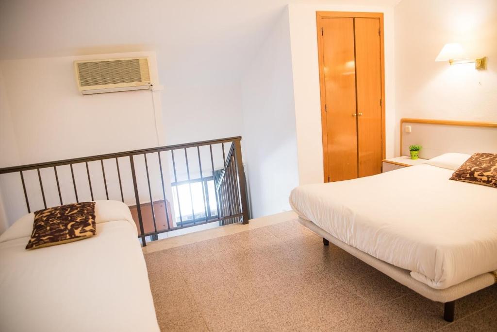 Postel nebo postele na pokoji v ubytování Hotel Prado Real