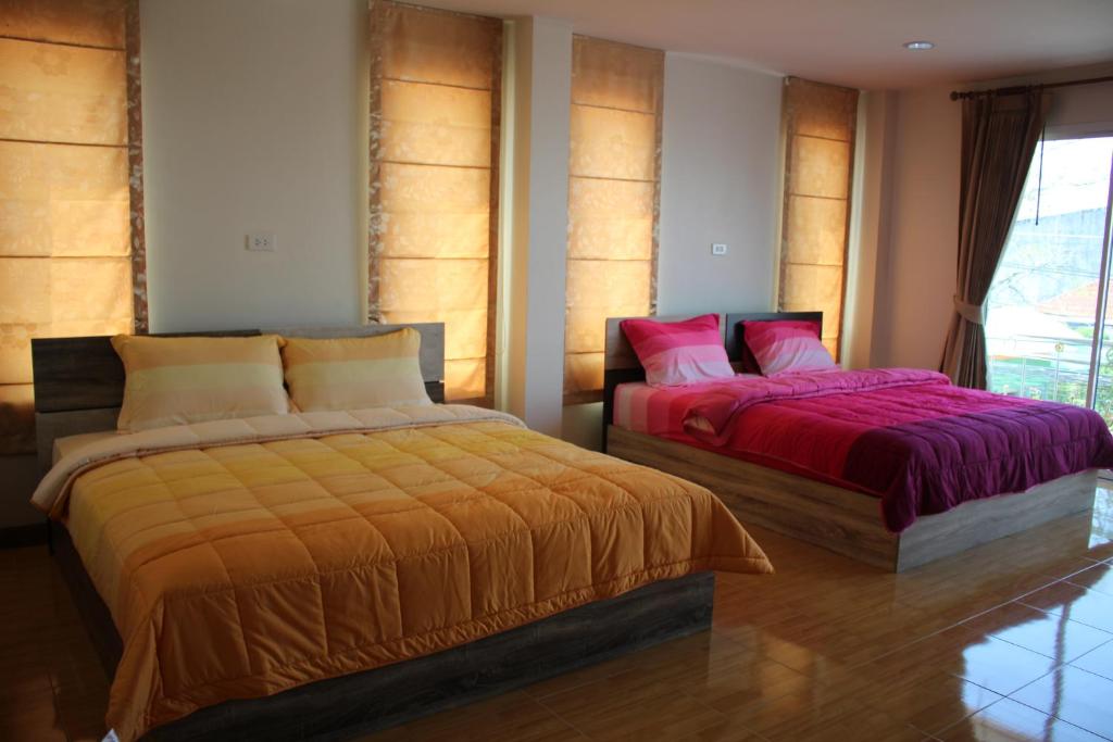Postel nebo postele na pokoji v ubytování Uncle House Krabi