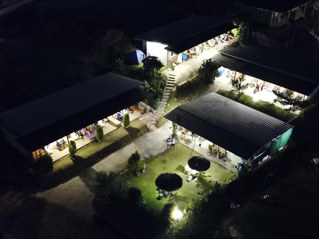 an overhead view of a courtyard with umbrellas at night at Cat Bungalow in Ko Lanta