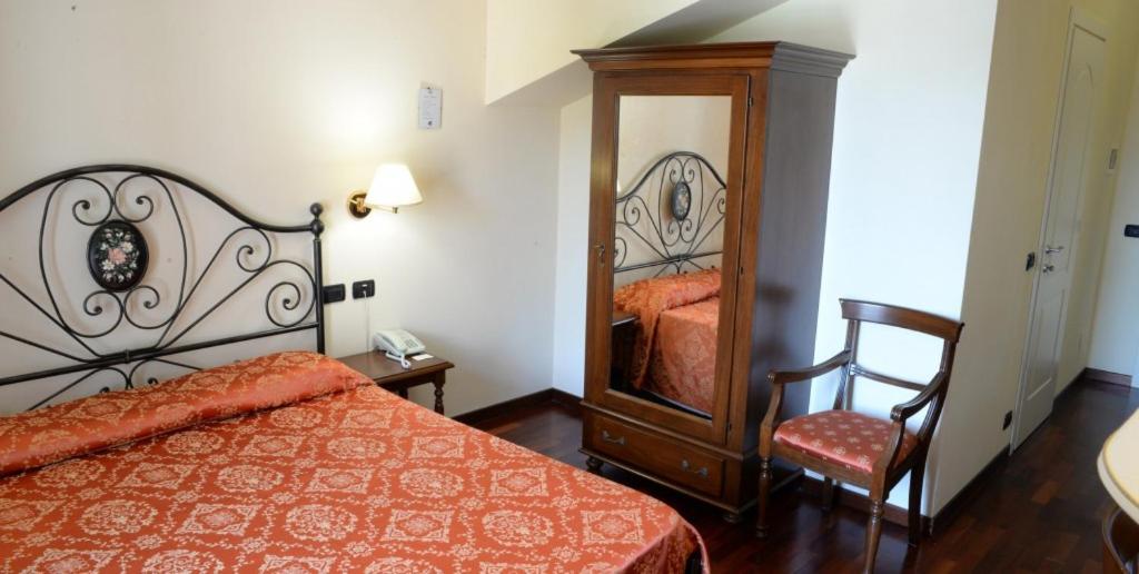 Postel nebo postele na pokoji v ubytování Villa Chiara Hotel