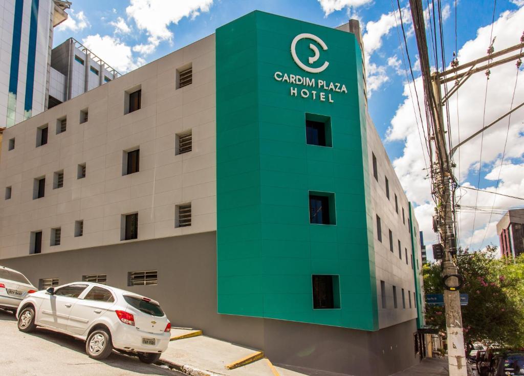 a building with a green sign on the side of it at Cardim Plaza Hotel in São Paulo