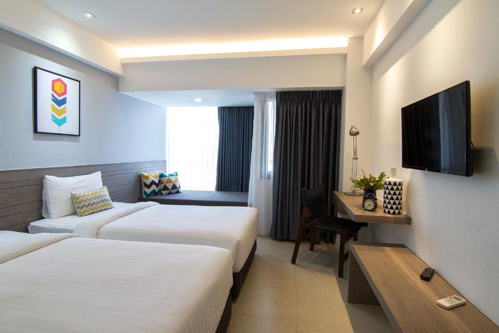 Postel nebo postele na pokoji v ubytování Bossotel Chiang Mai