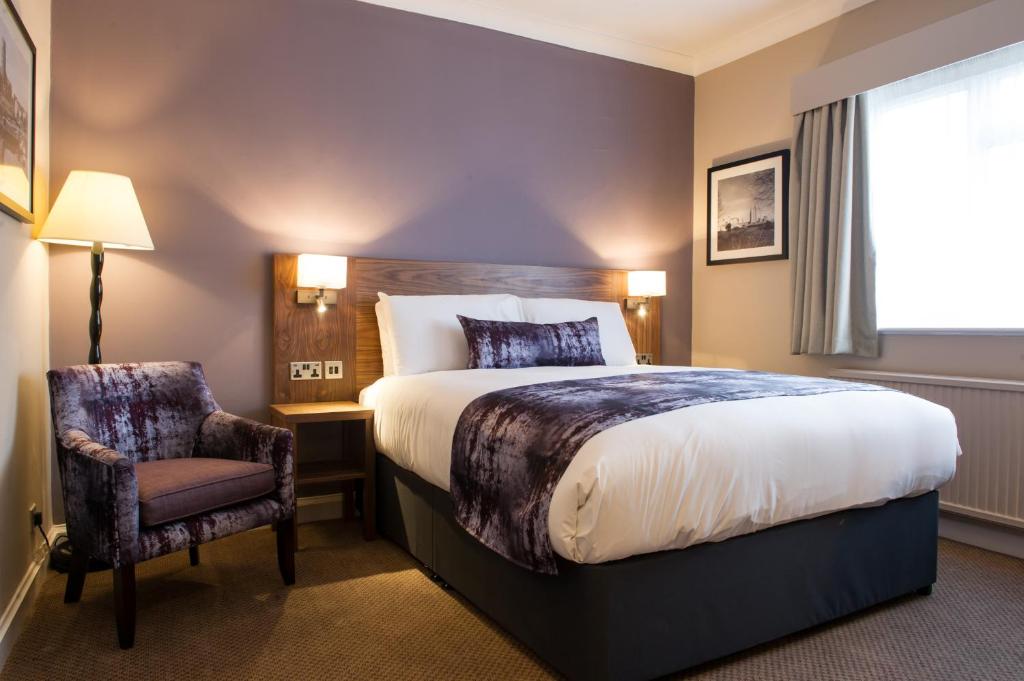 a hotel room with a bed and a chair at Toby Carvery Doncaster by Innkeeper's Collection in Doncaster