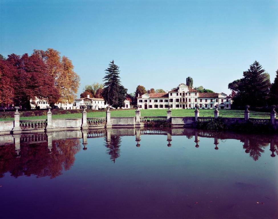 uitzicht op een vijver voor een gebouw bij Villa Toderini in Codognè