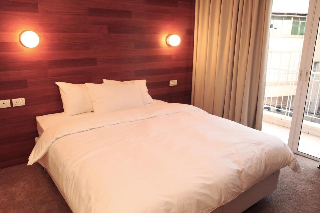 Postel nebo postele na pokoji v ubytování Idelson Hotel