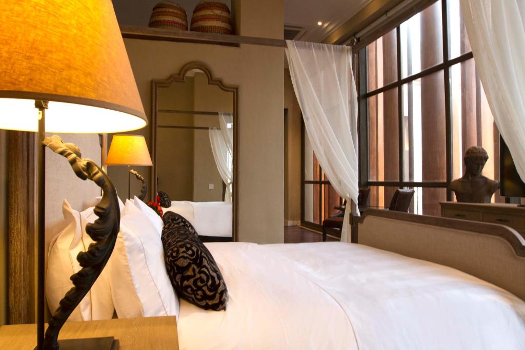 Postel nebo postele na pokoji v ubytování Bastión Luxury Hotel