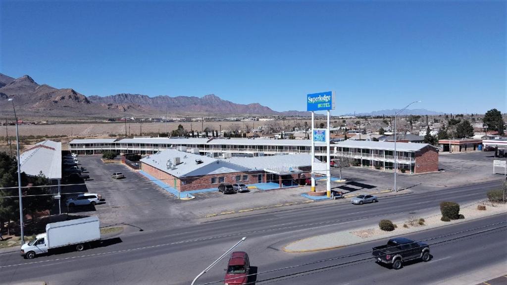 een stadsstraat met een parkeerplaats en een gebouw bij Super Lodge Motel El Paso in El Paso