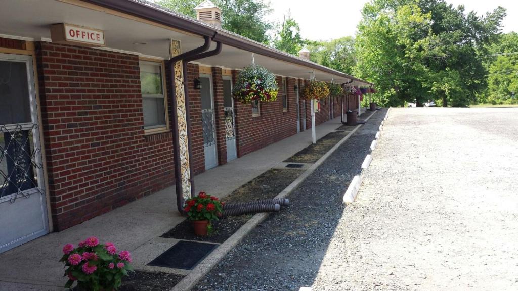 a building with flowers on the side of it at Slumberland Motel Mount Holly in Mount Holly