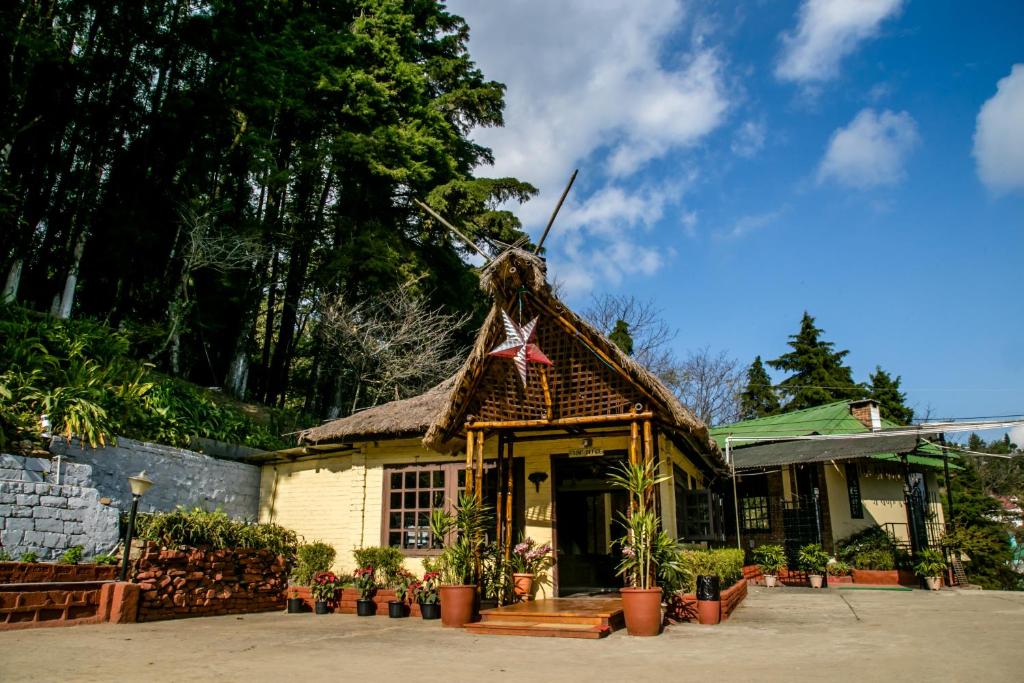 a building with a thatched roof with a star on it at Niraamaya Retreats Aradura Kohima in Kohīma