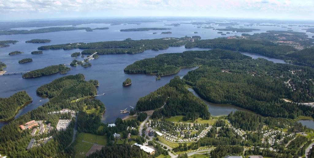 an aerial view of a lake with trees and houses at Rauhalahti Holiday Homes in Kuopio