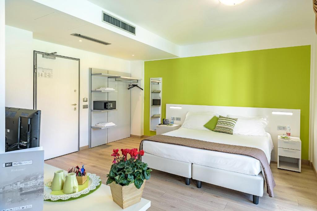 Postel nebo postele na pokoji v ubytování Hotel Vischi