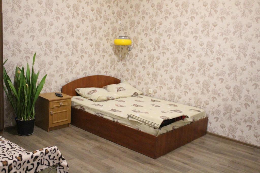 a small bedroom with a bed and a plant at квартира in Odesa