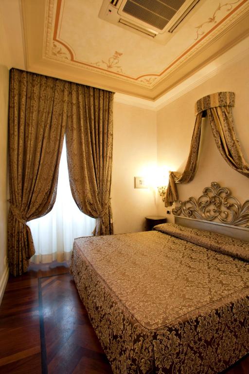 Uma cama ou camas num quarto em Hotel Aventino