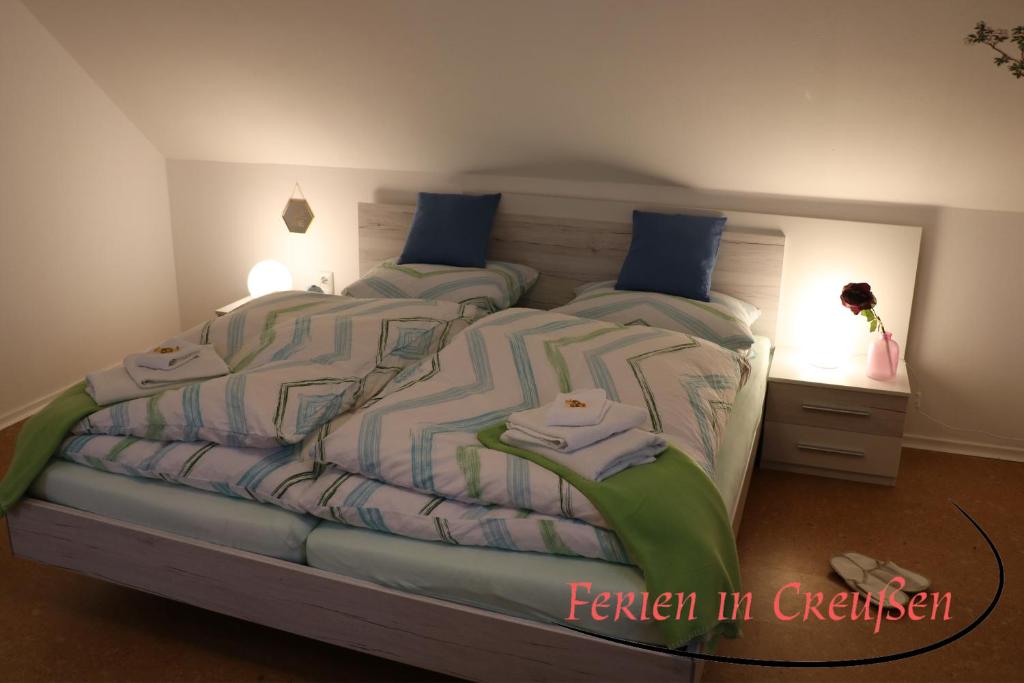 a bedroom with two beds and a night stand at Ferien in Creußen in Creußen