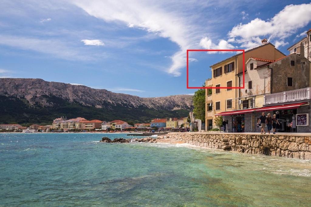 a view of a beach with a red box at Apartment Frane in Baška