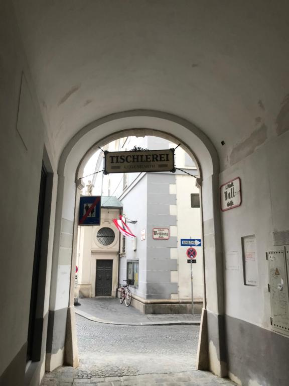 an archway in a building with a sign that reads treasurer at The Barts City Center - Self Check-in in Vienna