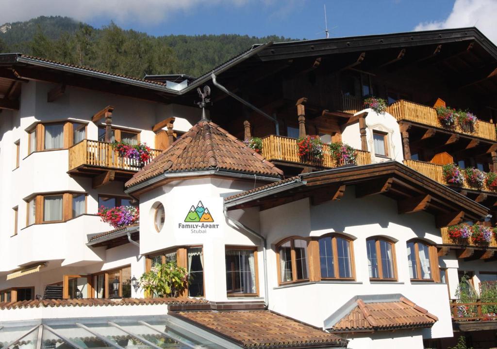 a large white building with windows and balconies at Family Apart Stubai in Fulpmes