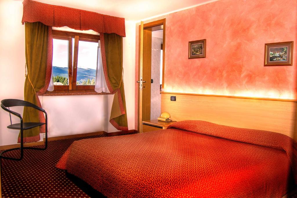 Postel nebo postele na pokoji v ubytování Hotel Belvedere