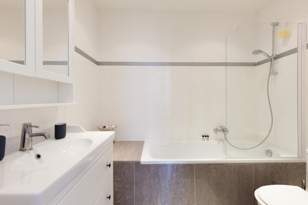 a white bathroom with a sink and a shower at Mouette in Cannes