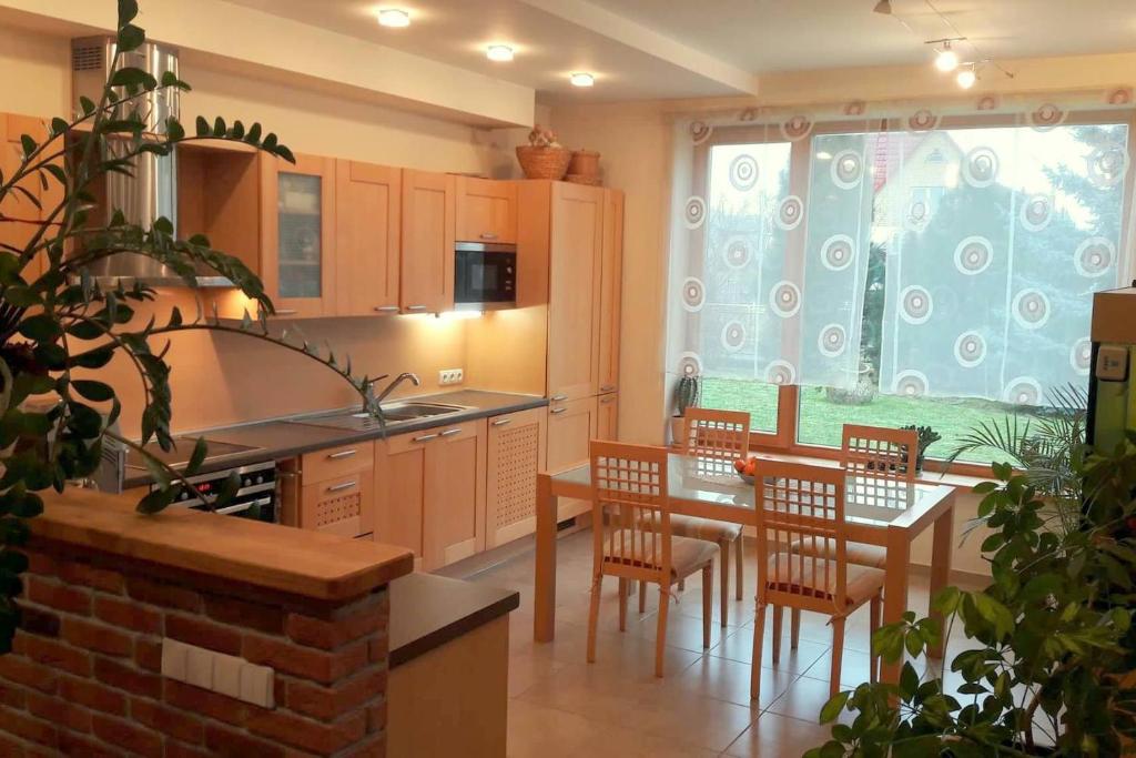 a kitchen with a table and chairs and a dining room at Apartamentai Luna in Panevėžys