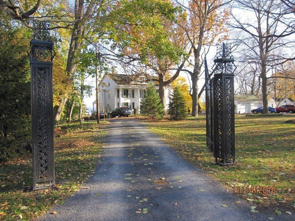 a driveway leading to a house with two iron gates at Renwick Clifton House B&B in Saugerties