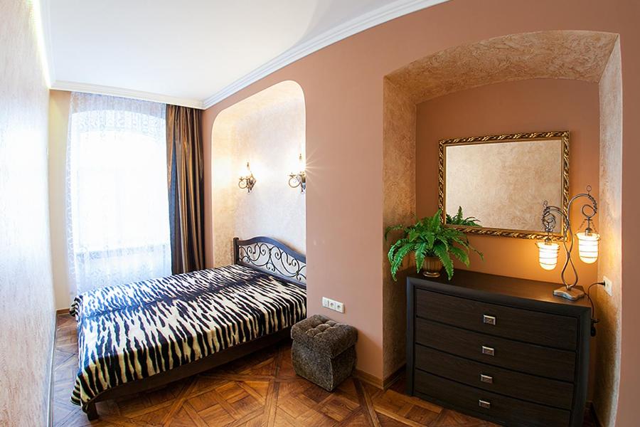 a living room with a dresser and a mirror at Rynok Square - the heart of Lviv in Lviv