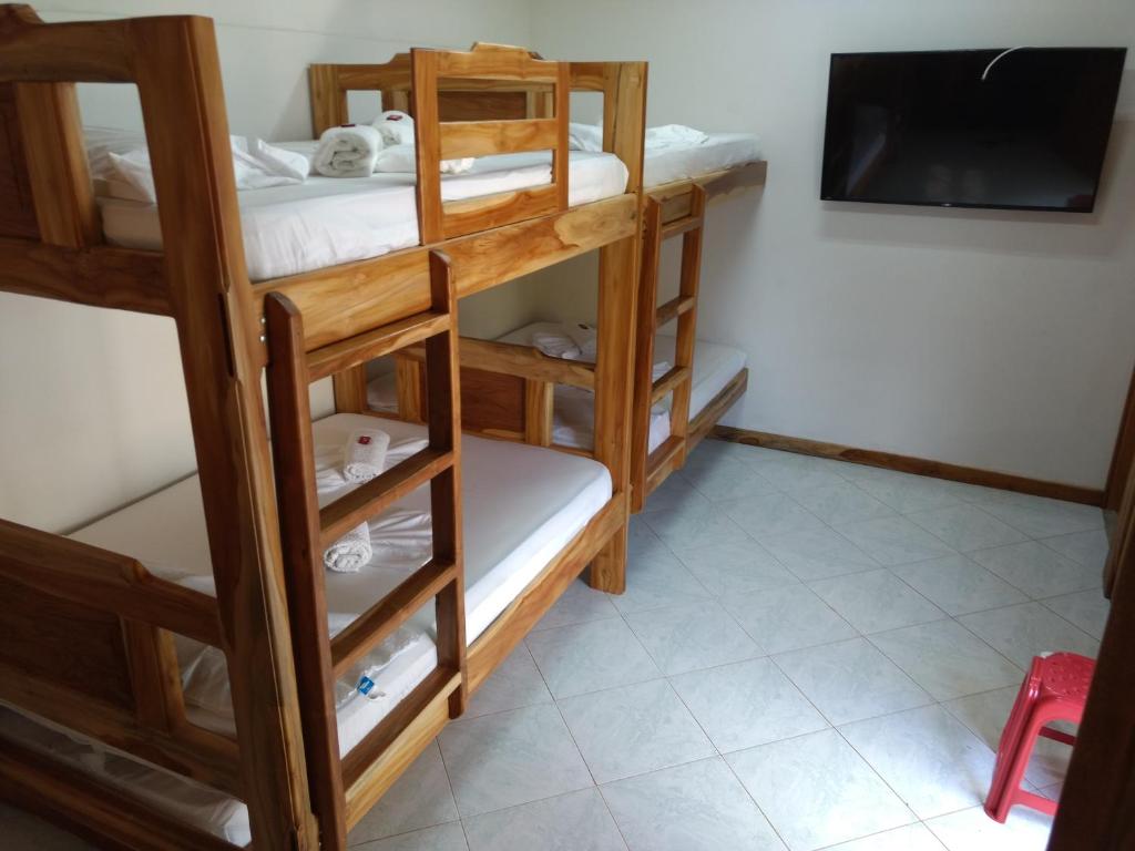 a room with bunk beds and a flat screen tv at Cabaña Kosta Azul Capurganá in Capurganá