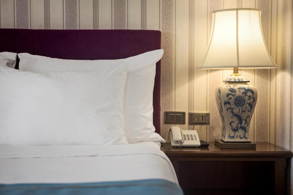 Postel nebo postele na pokoji v ubytování Maro Hotel