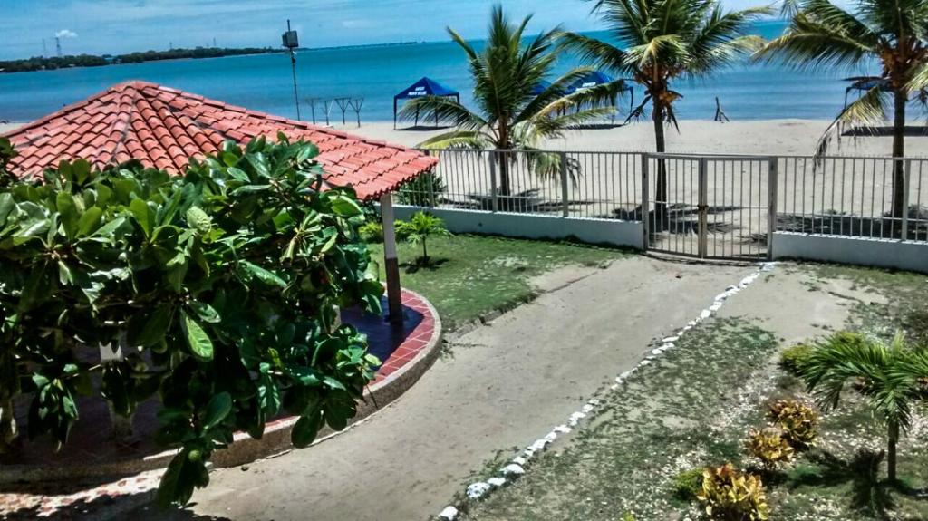 una entrada que conduce a una playa con palmeras en Cabaña Coveñas, en Coveñas