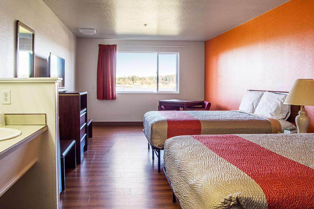 a hotel room with two beds and a window at Motel 6-Newport, OR in Newport