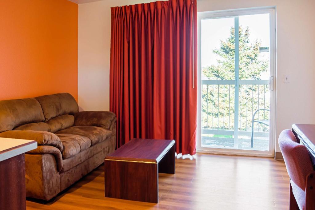 a living room with a couch and a large window at Motel 6-Newport, OR in Newport