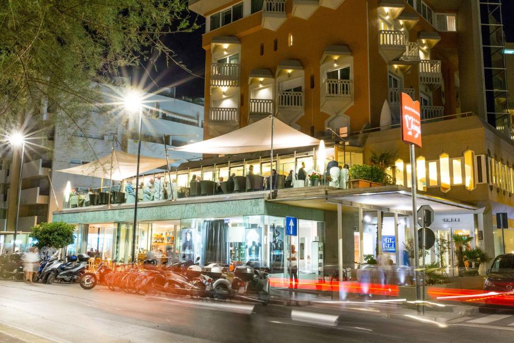 a building on a city street at night at City Hotel in Senigallia