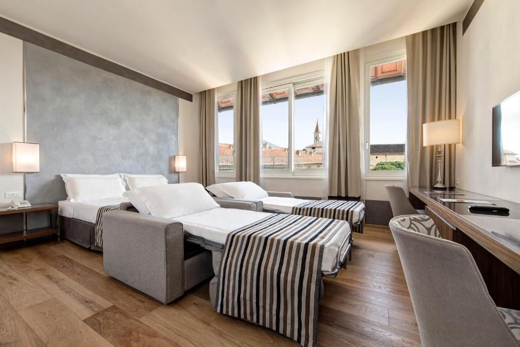 Postel nebo postele na pokoji v ubytování Hotel Orto de' Medici