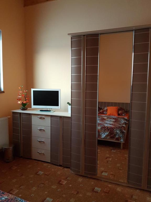 a room with a computer on a cabinet with a monitor on it at Pension Sunset Mezirolí in Nová Role