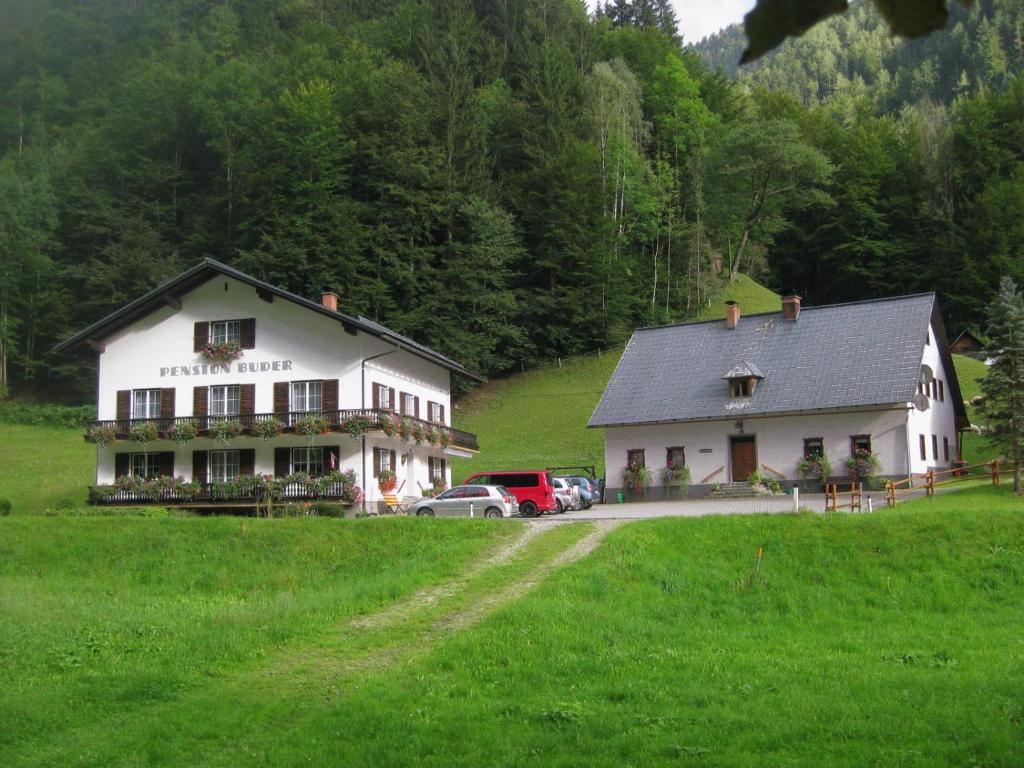 un gran edificio blanco con coches aparcados en un campo en Ferienhaus Mendlingbauer, en Lassing